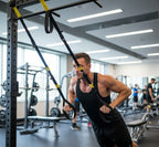 Flexora Suspension Trainer (TRX) shown hanging with adjustable straps and handles for full-body workout exercises.