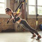Flexora suspension trainer for women, featuring adjustable straps and handles for full-body resistance exercises.